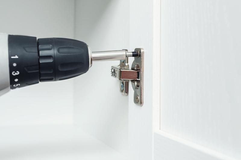 Installing hardware hinges for cabinet doors using rotary drilling tools