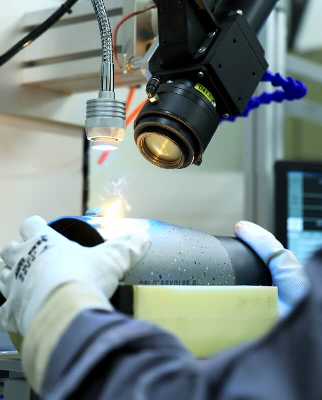 Technicians are carving logos for thermos cups